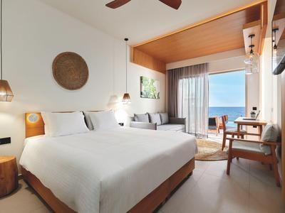 Cozy wellness room with massage table, soft lighting, and modern doors.