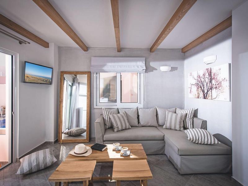 Modern living room with gray sectional sofa, wooden coffee table, and wall-mounted TV.