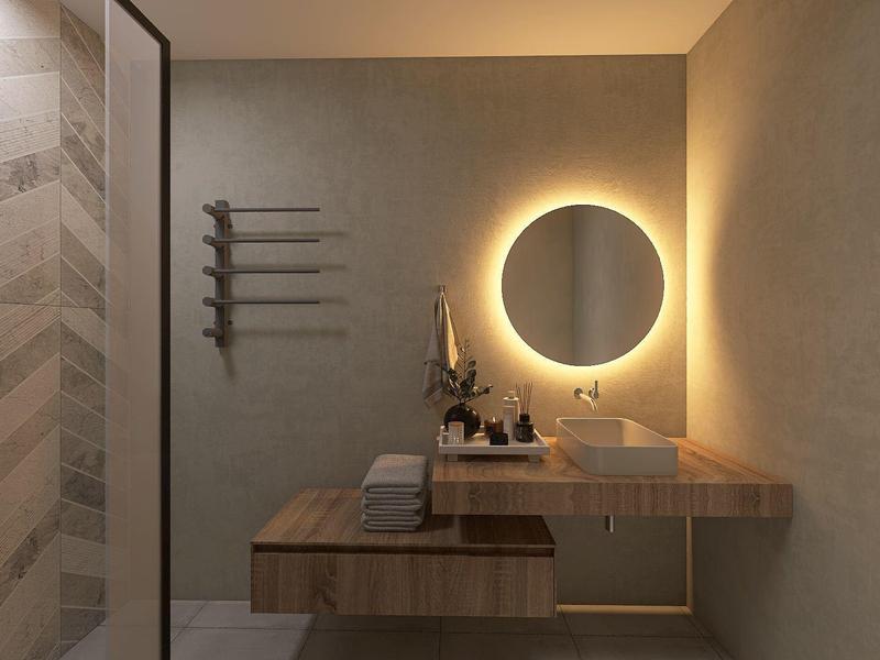 Modernes Badezimmer mit beleuchtetem runden Spiegel, Holzregal und grauen Wänden.