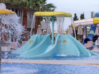 Kolorowy plac zabaw wodny ze zjeżdżalniami i fontannami w basenie hotelowym