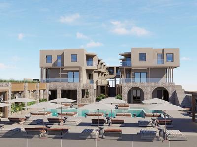 Moderní hotelový komplex s několika budovami a bazénem pod modrou oblohou.