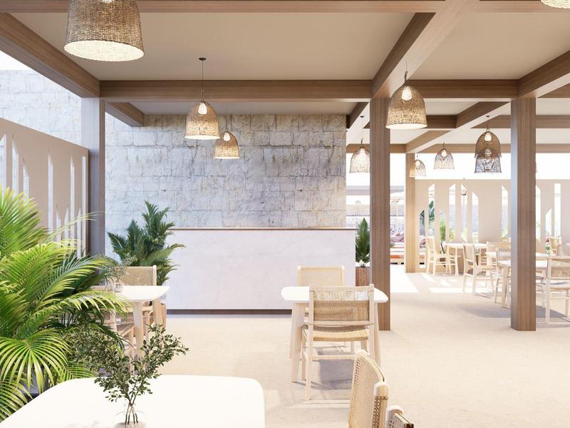 Helles, modernes Restaurant mit weißen Möbeln und viel natürlichem Licht