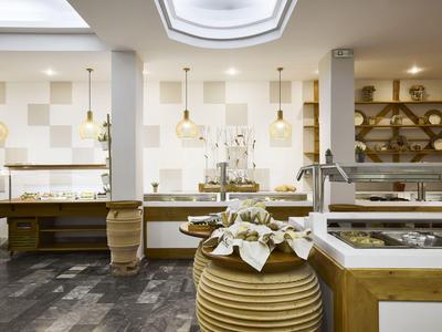 Modern buffet with wooden counters and pendant lights in a bright dining area.