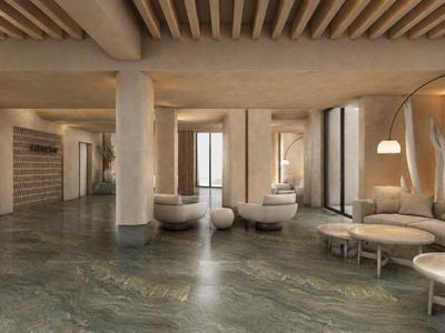 Moderner Hotel-Loungebereich mit runden Sofas, Säulen und warmem Beleuchtungskonzept.