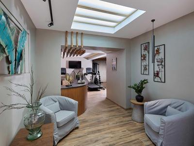 Zona d'attesa luminosa con due poltrone, piante e arredamento moderno in un hotel