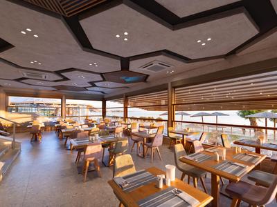 A modern restaurant with wooden chairs and tables overlooking the sea.