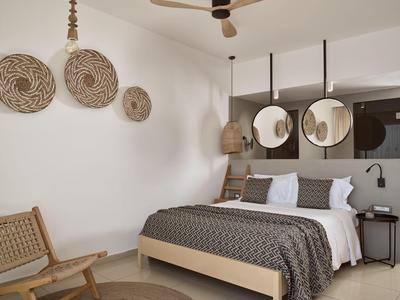 Camera da letto moderna con letto in legno, specchi rotondi e cestini decorativi a parete.