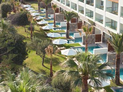 Hotel mit Zimmern, die jeweils einen privaten Pool auf einem grünen Hang haben.