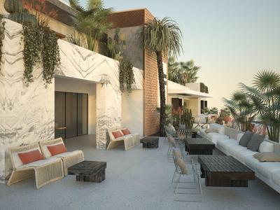 Área exterior moderna con asientos cómodos y plantas en un hotel.