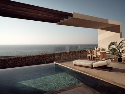 Moderner Außenbereich mit Pool, Tagesbett, Esstisch und Meerblick bei klarem Himmel.