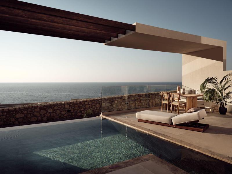 Modern infinity pool with lounge area overlooking calm sea and outdoor dining setup.