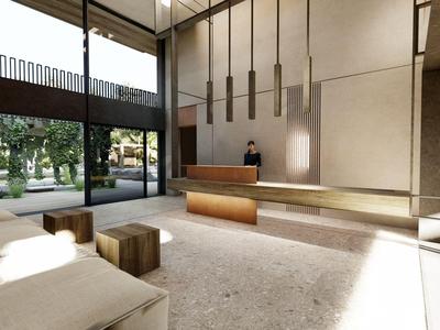 Hall dell'hotel moderno con soffitti alti, arredamento minimalista e grandi finestre.