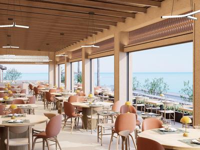 Restaurante luminoso con muebles modernos de madera y vistas al mar a través de grandes ventanas.
