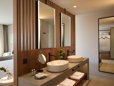 Modern bathroom with two sinks, large mirrors, and a full-length wall mirror