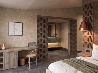 Modern hotel room with desk, bed, and warm wooden accents.