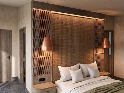 Modern hotel room with double bed, warm lighting, and contemporary wall design.