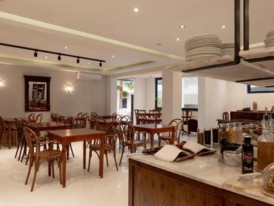 Bright and modern dining area with wooden tables and chairs in a well-lit space.