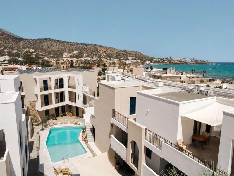 Modern hotel complex with pool near the coast with views of the sea and hills