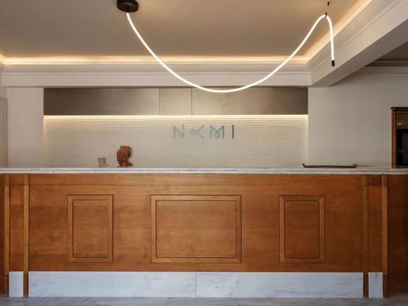 Modern hotel reception with light wood and minimalist lighting