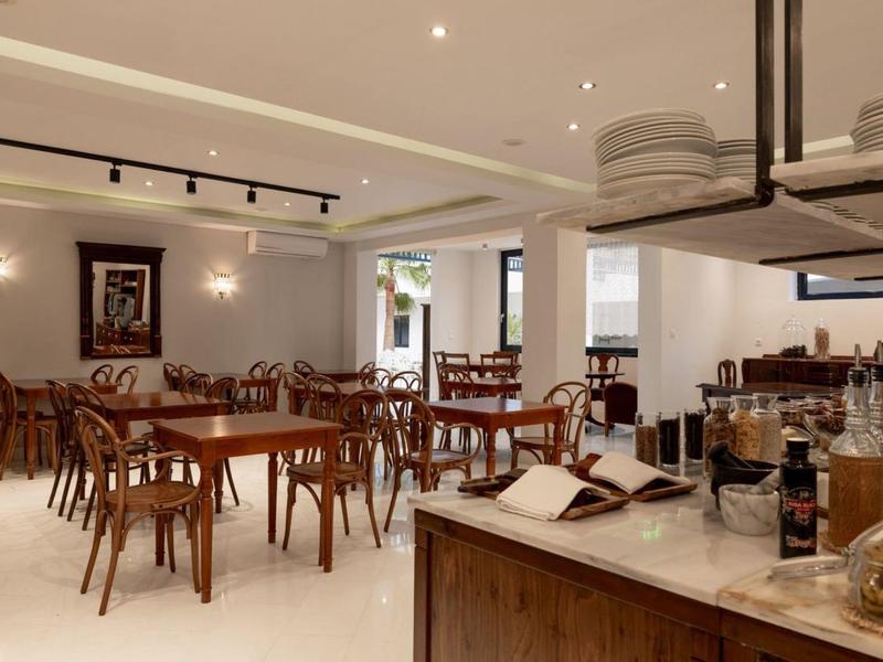 Bright and modern dining area with wooden tables and chairs in a well-lit space.