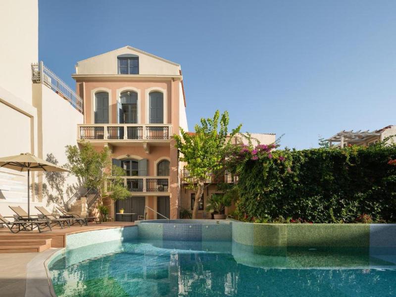 Courtyard with pool and multi-story building under clear sky