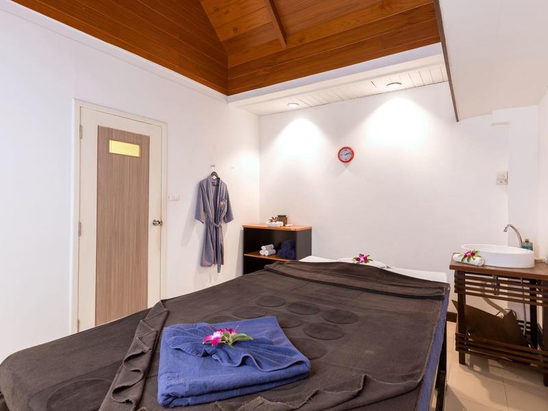 Cozy massage room with warm lighting and decorative accents.