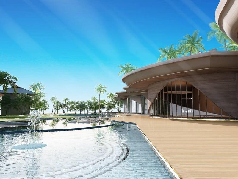 Modern hotel pool with stylish wooden deck and tropical landscape in the background.