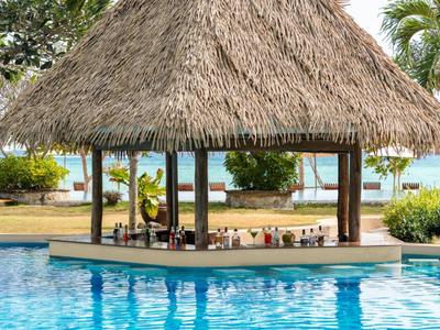 Floating pool bar with thatched roof in a tropical resort
