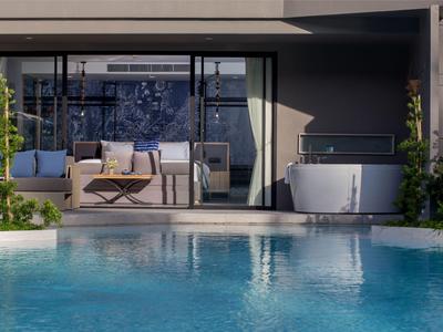 Moderner Außenbereich mit Pool, Sitzbereich und freistehender Badewanne neben einem modernen Gebäude.