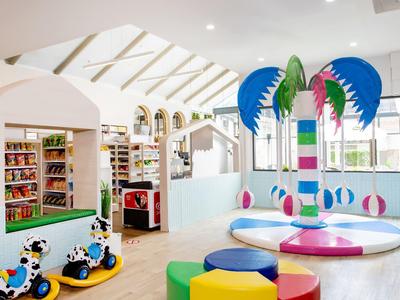 Bright, child-friendly playroom with colorful toys and seating in a bright space.