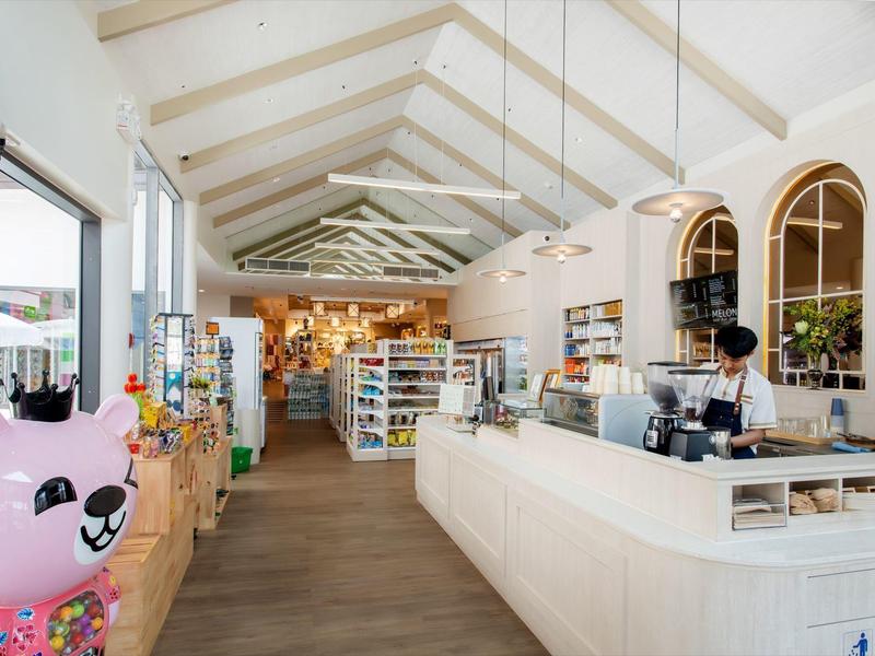 Bright, modern store with high ceilings, display shelves, and a white counter.
