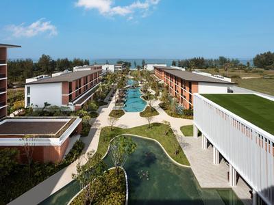 Complejo hotelero moderno con piscina y áreas verdes, rodeado de naturaleza y vista al mar.