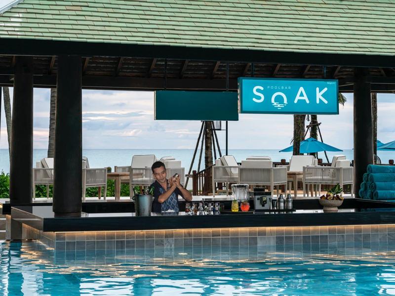 Bar u bazénu s posezením, pohled na vodu a pláž v pozadí