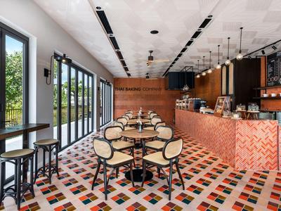 Salle à manger d'hôtel moderne avec carrelage coloré et tables et chaises élégantes.