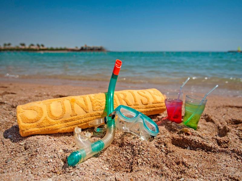 Strand mit Sand, Schnorchelset, zwei farbige Getränke in Gläsern und Handtuch mit Aufschrift "DUNERIS".