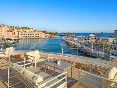 View of a marina with seating area in the foreground under clear sky