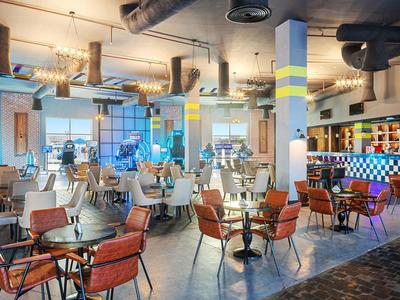 Modern indoor restaurant with chairs, tables, and a decorative bar