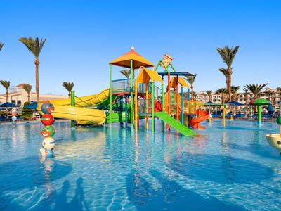 Wasserpark mit bunten Rutschen und Spielgeräten in einem Hotelpool bei sonnigem Wetter.