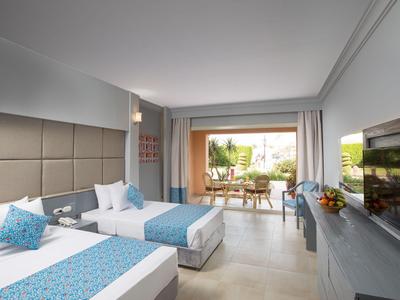 Nowoczesny pokój hotelowy z dwoma pojedynczymi łóżkami i balkonem z miejscami do siedzenia.