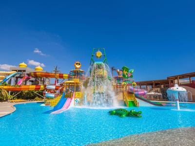Colorful water park with slides and water features on a sunny day.