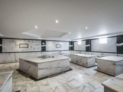 Moderner Hotel-Wellnessbereich mit Marmorbecken und stilvoller Beleuchtung.