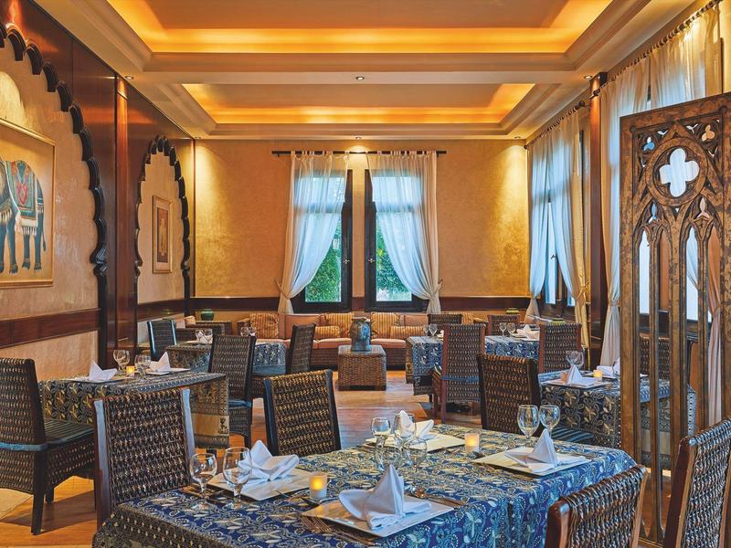 Elegant restaurant with set tables and warm lighting ambiance.