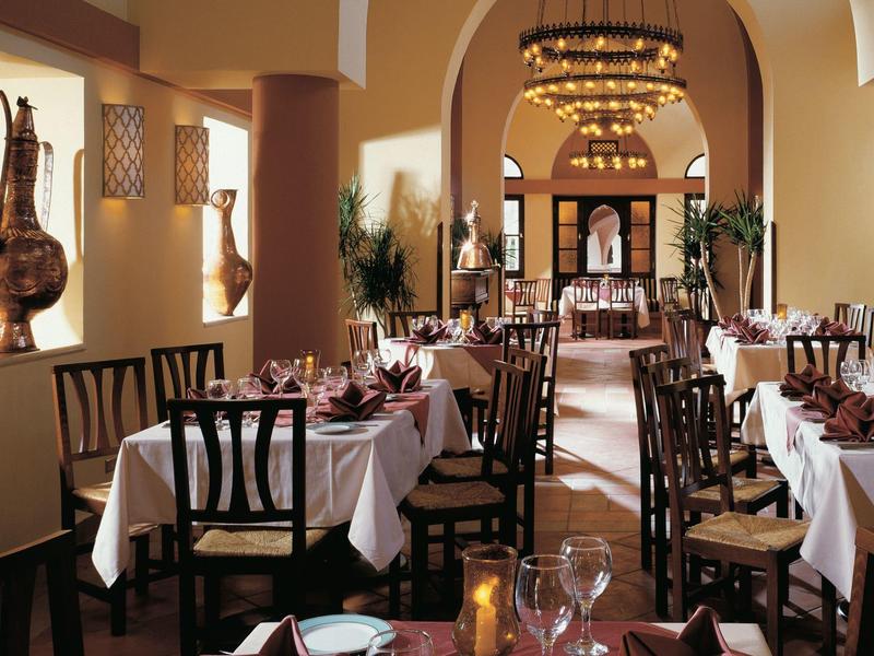 Elegant restaurant with set tables and warm lighting, perfect for fine dining.