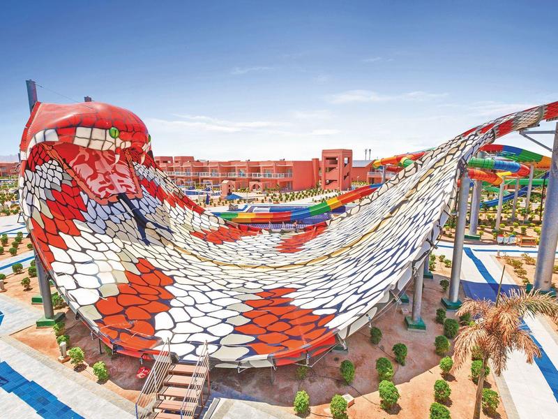 Huge colorful water slide in a water park under clear sky.