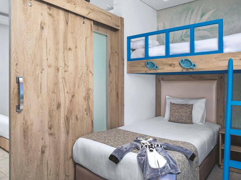 Room with single bed, bunk bed, and wooden sliding door in modern style