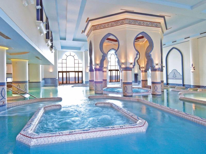 Indoor pool with an oriental design and blue tiles in a hotel.