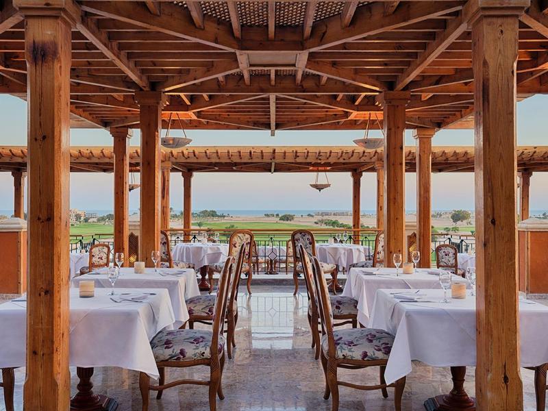 Open restaurant with wooden accents and view of the landscape in the background.