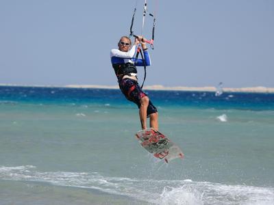 Man kite surfing over the sea on a sunny day