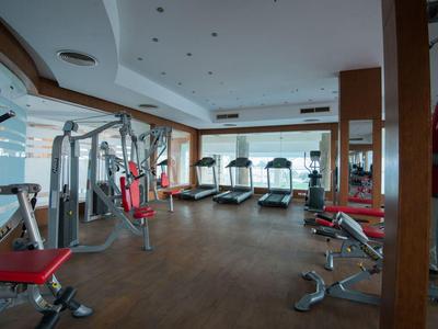 Interior view of a modern gym with various exercise machines and treadmills.