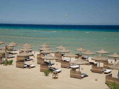 Beach with sun loungers and umbrellas by the turquoise sea